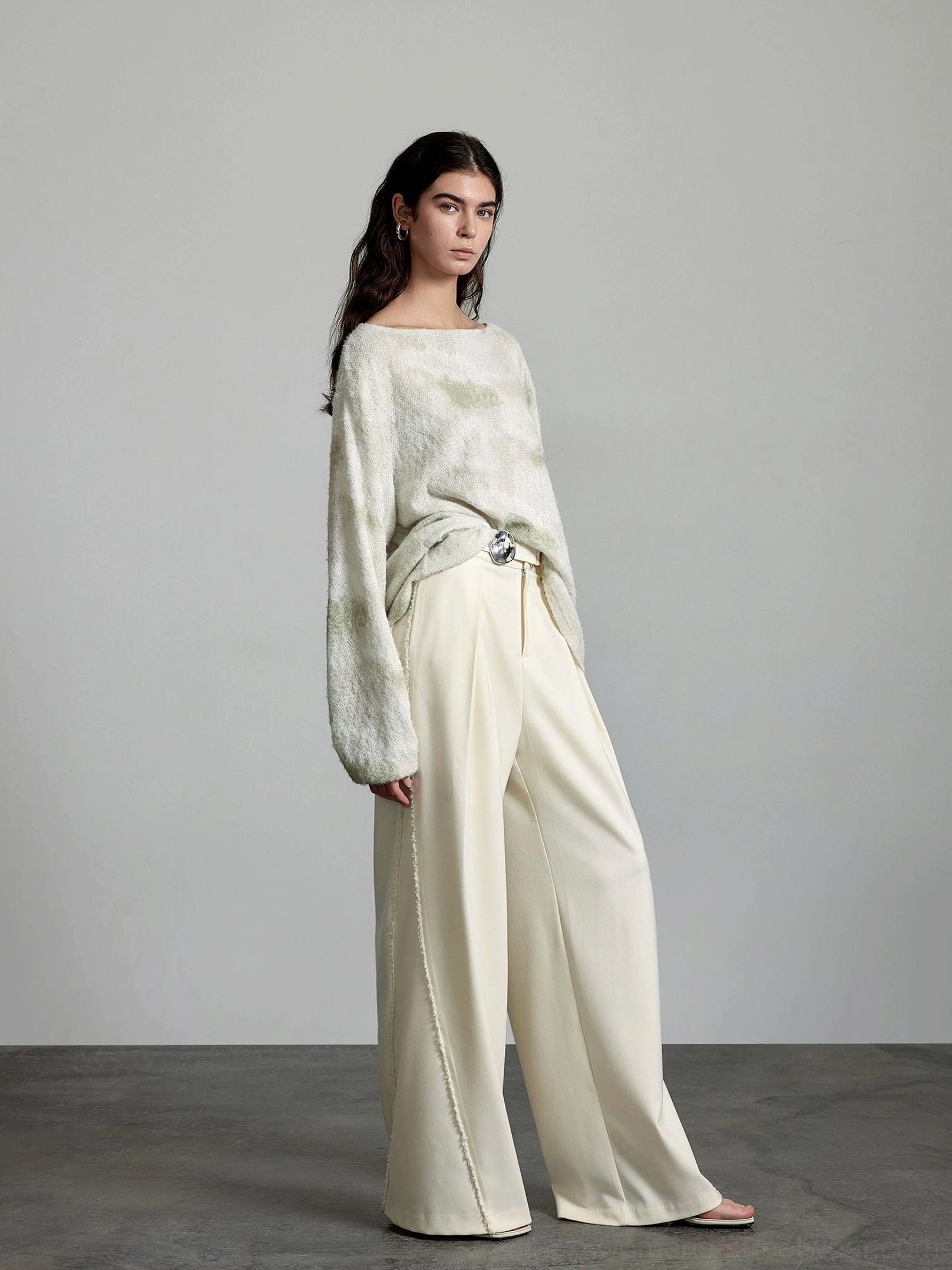 Left side view of high-waisted cream tailored trousers styled with a minimalist Korean streetwear outfit