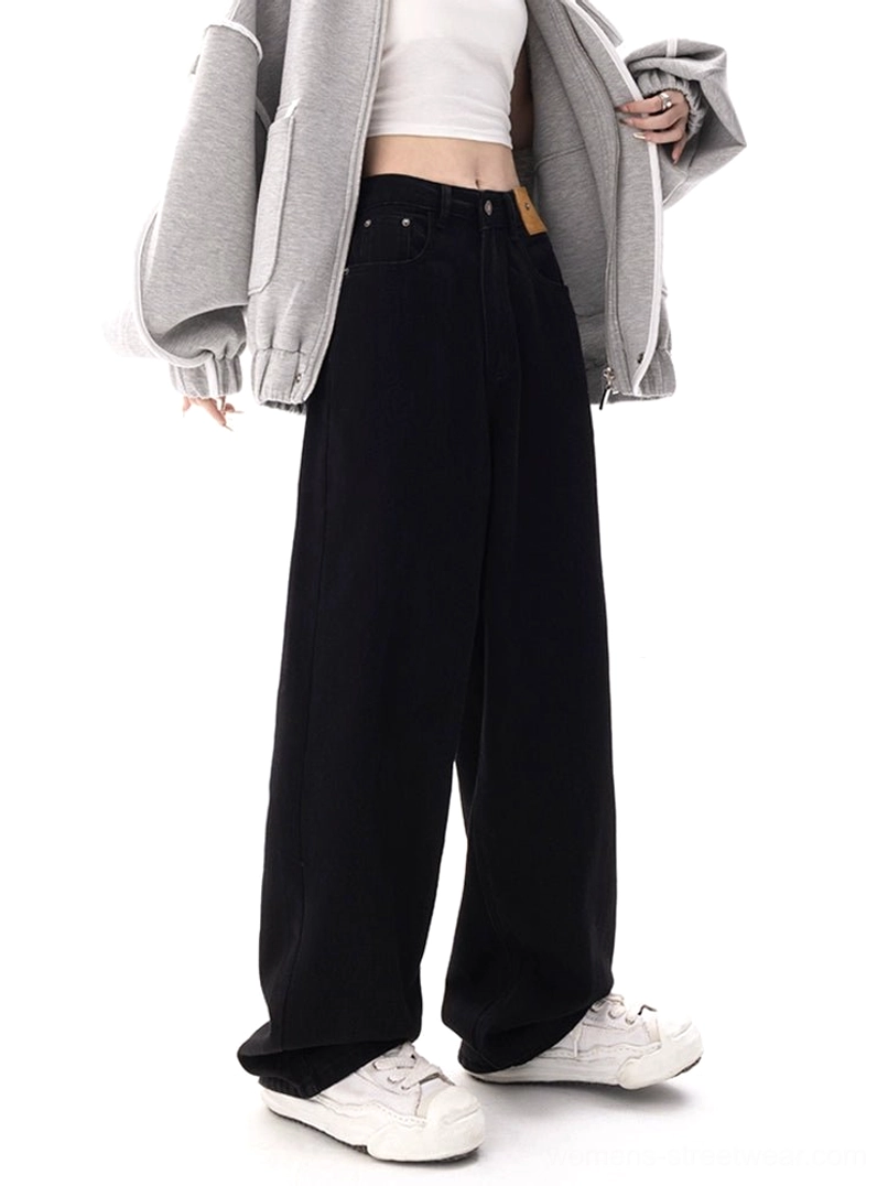 High-waisted dark blue wide-leg denim jeans in a three-quarter front view, styled with an oversized gray coat for contemporary Korean street fashion