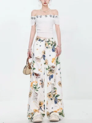 Full front view of high-waisted floral print distressed wide-leg jeans with relaxed streetwear fit