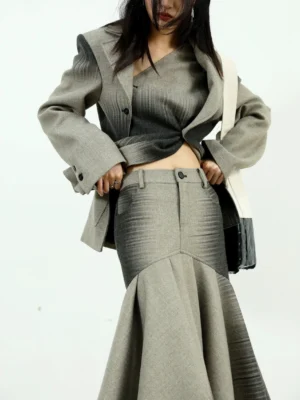 High-waisted gray ombre fishtail maxi skirt styled with an asymmetrical cropped blazer and matching tote bag in modern Seoul fashion