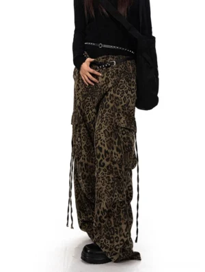 Three-quarter front view of high-waisted leopard print streetwear cargo pants with a relaxed wide leg fit and adjustable side drawstrings