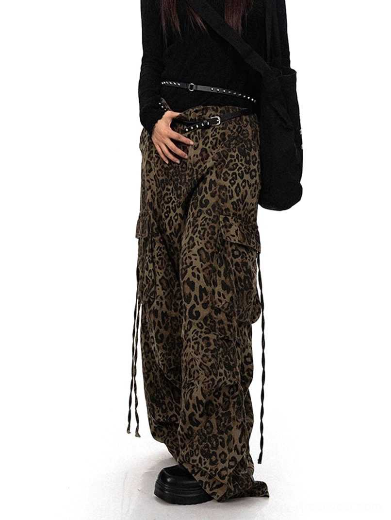 Three-quarter front view of high-waisted leopard print streetwear cargo pants with a relaxed wide leg fit and adjustable side drawstrings