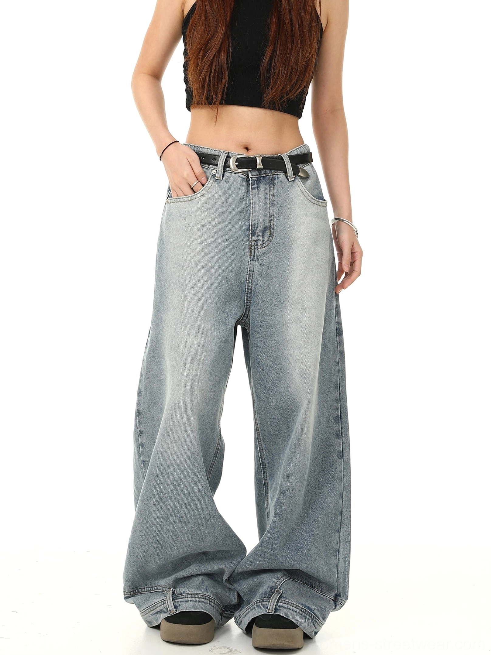 Angled front view of high-waisted light blue acid-washed baggy jeans with floor-length wide legs and oversized Korean streetwear fit