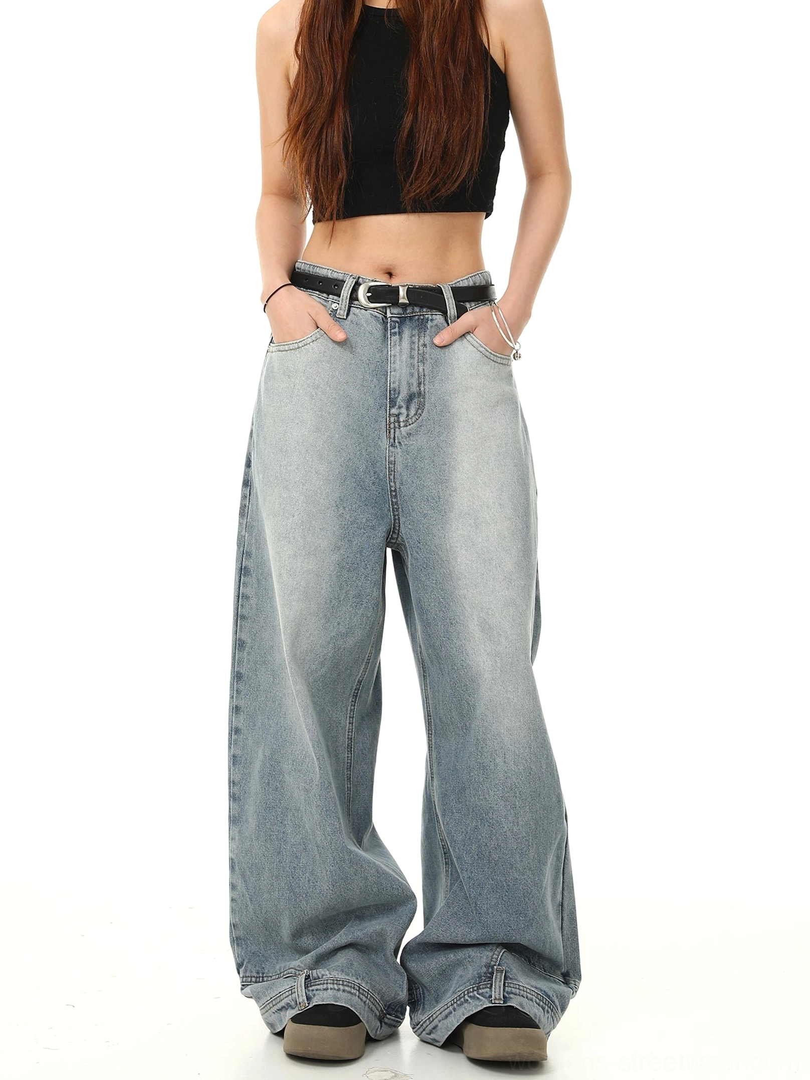 Front side view of light blue high-waisted Y2K baggy jeans with wide-leg denim cut, relaxed fit, belt styling, and functional pockets