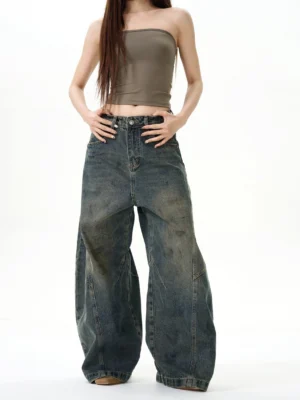 Front view of high-waisted retro blue wide-leg jeans showing the classic denim waistband and oversized Y2K streetwear silhouette