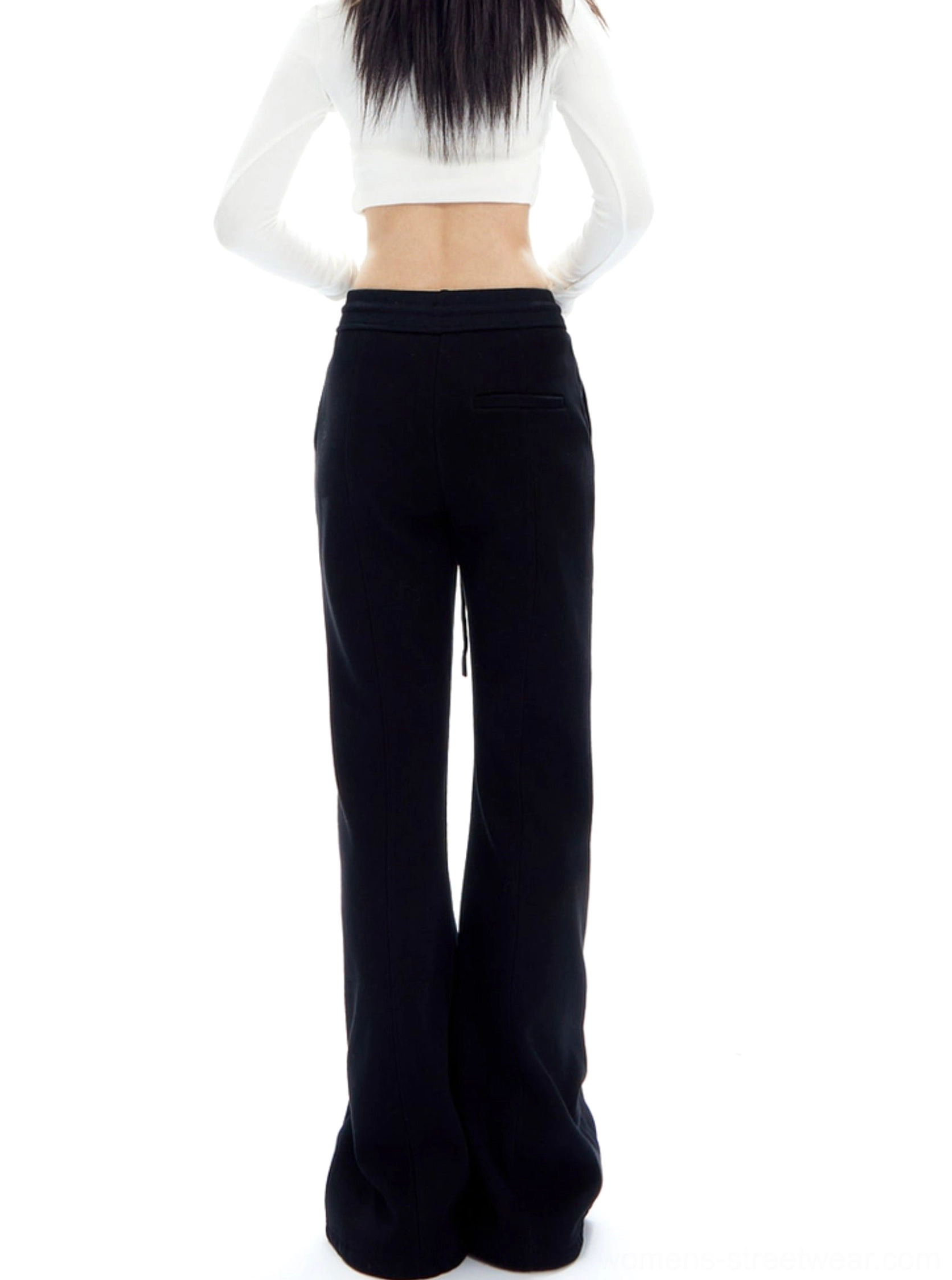 High-waisted wide-leg streetwear trousers highlighting the relaxed flare and contemporary lounge fit