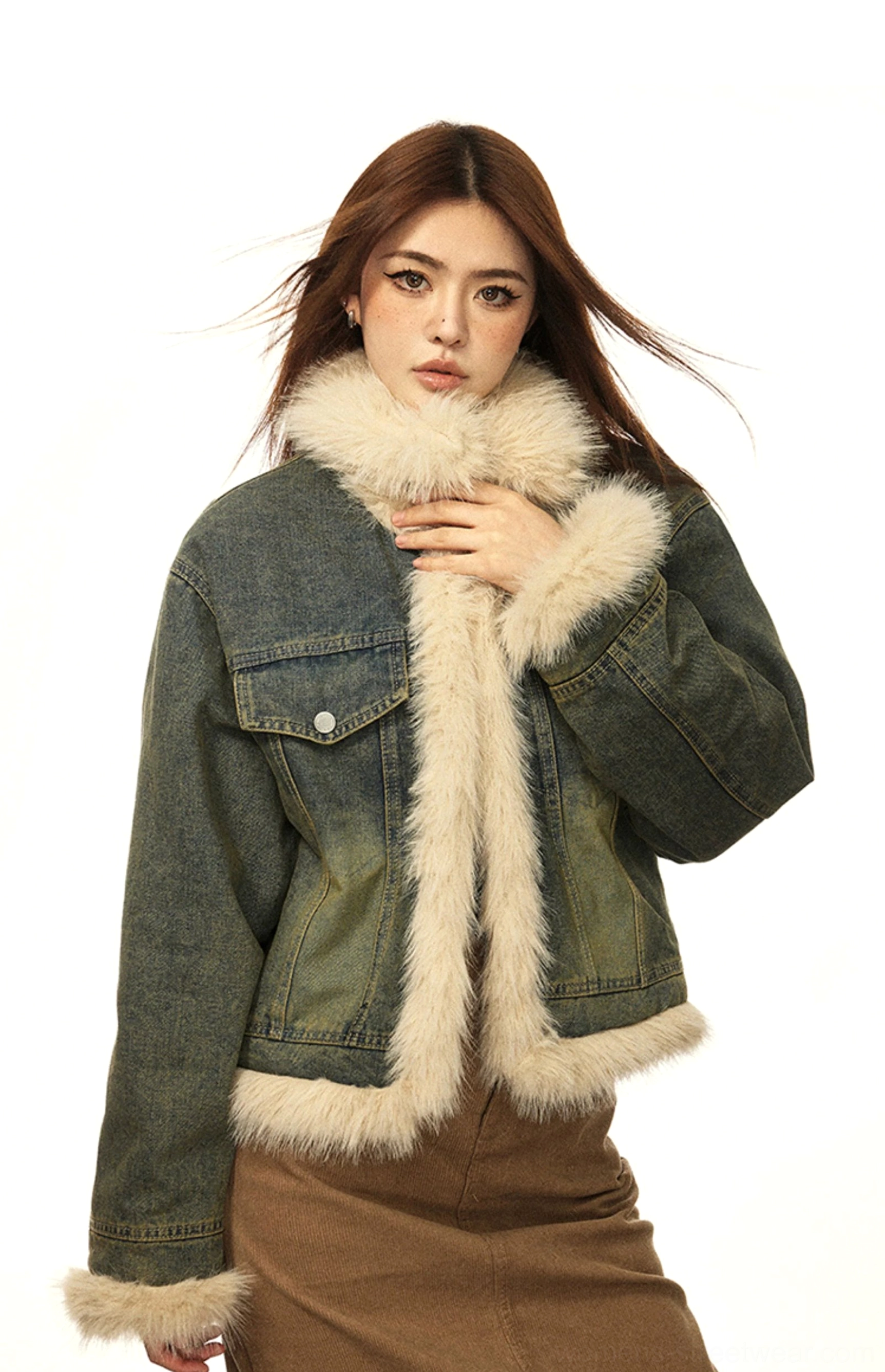 Close front three-quarter view of a high wrapped beige faux fur collar on a vintage blue denim winter jacket