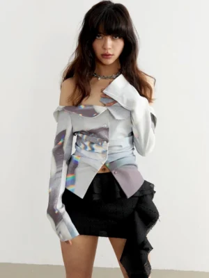 Front close-up of a woman wearing a white holographic marble off-shoulder long-sleeve streetwear top with ruched waist styling