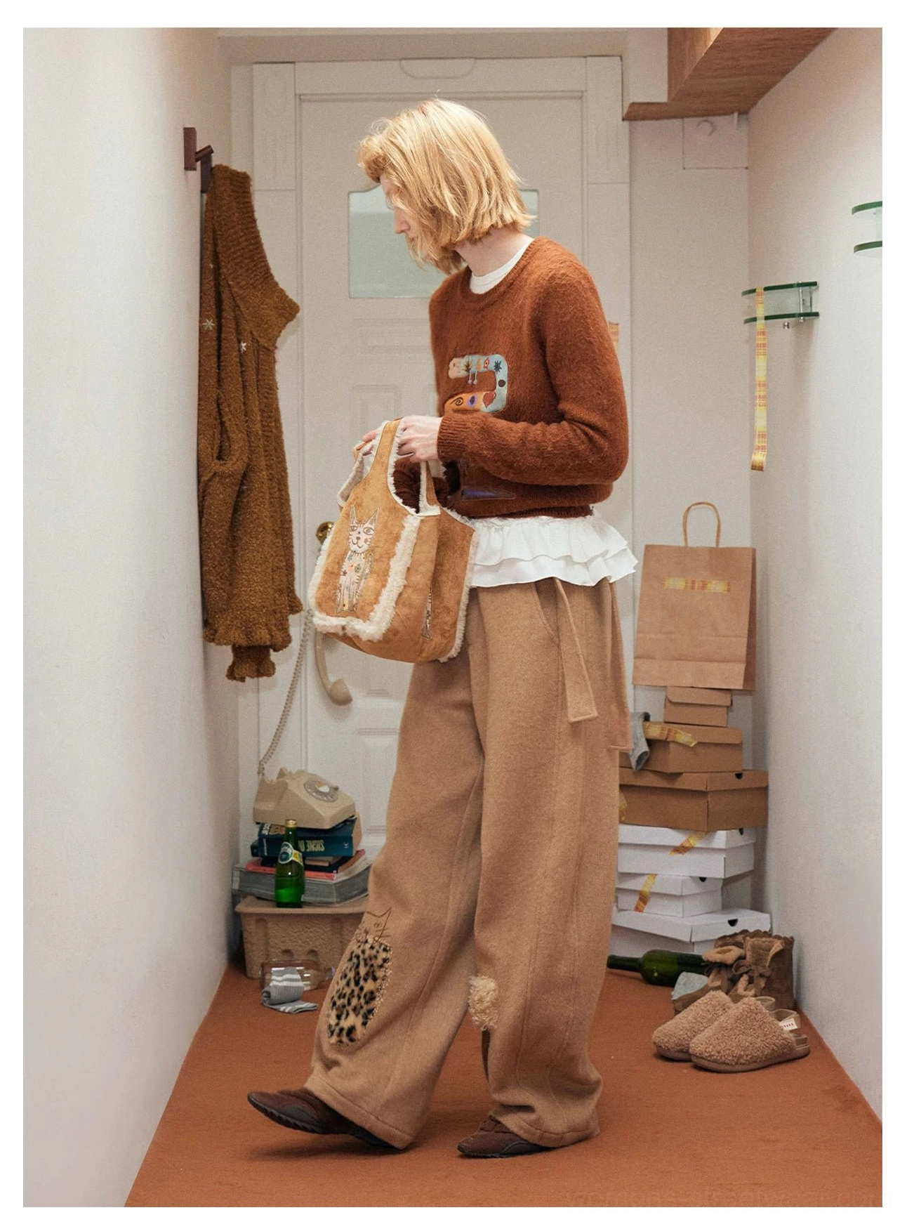 Honey brown faux suede cat embroidery tote bag with cream fleece trim styled in an indoor streetwear look