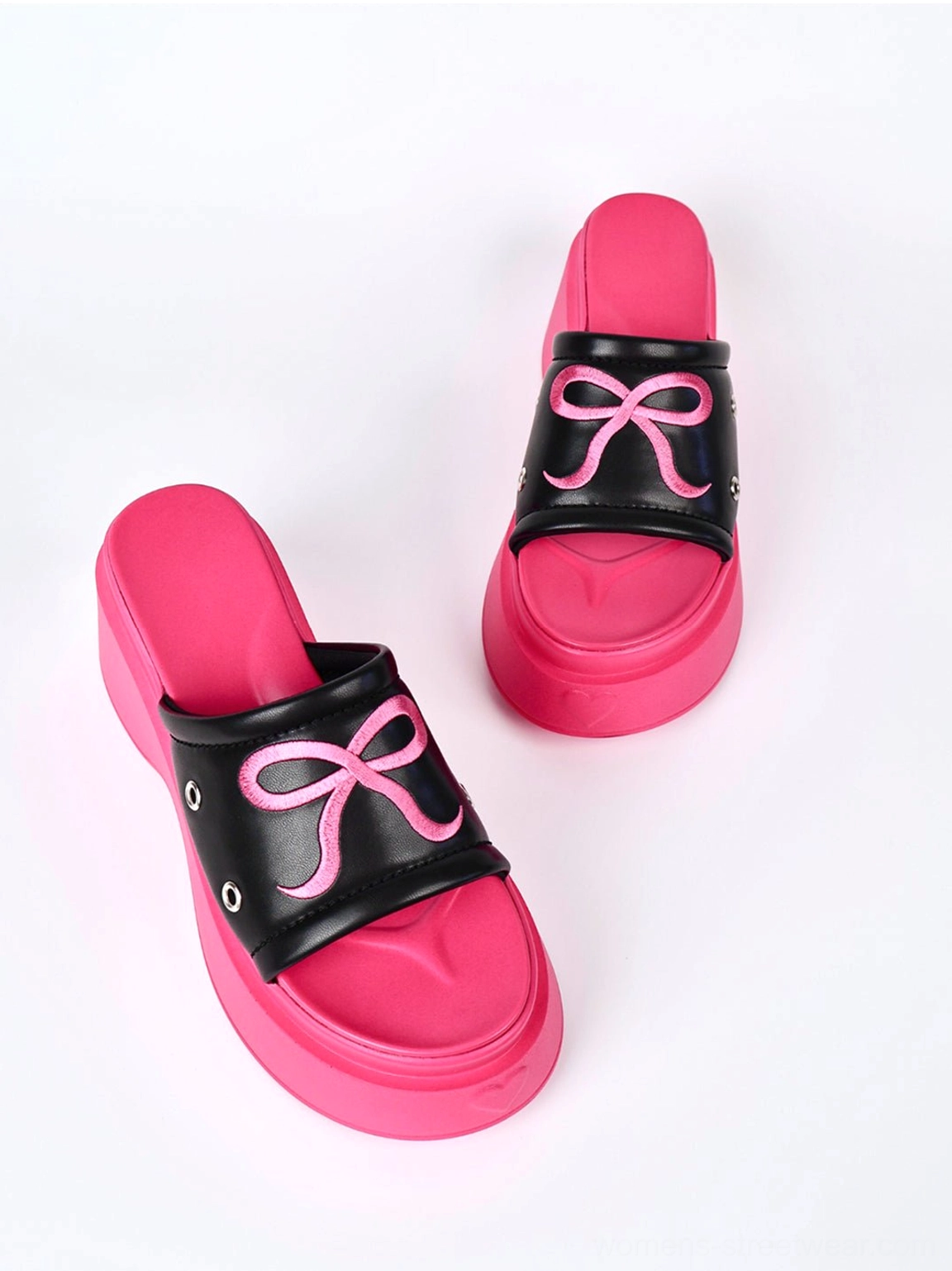 Full pair of hot pink bow platform sandals on a white background showing the open toe and thick platform sole