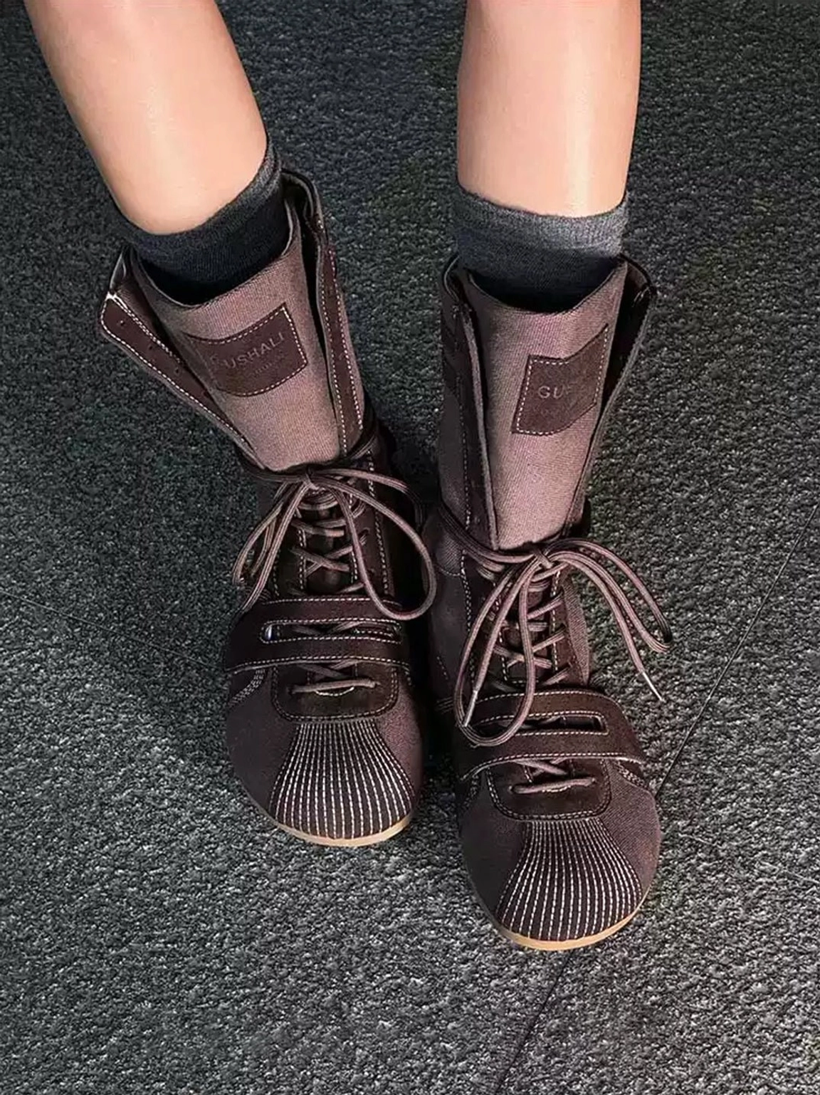 Overhead view of hybrid boxing boots worn with layered gray and black socks for a casual streetwear look