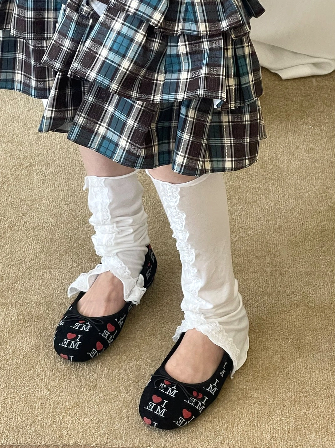Black I Love Me print round-toe ballet flats with bow detail styled with ruffled knee socks and plaid skirt