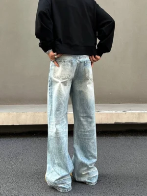 Rear full-body view of light blue ice fade straight jeans with relaxed wide-leg streetwear fit, vintage washed denim, and classic back pockets