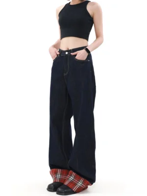 Front three-quarter view of navy blue indigo plaid cuff wide leg jeans styled with a black cropped tank top