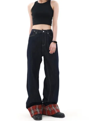 Full front view of dark indigo wide leg streetwear jeans with red tartan turned-up cuffs