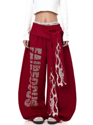 Burgundy red inferno wrap wide-leg fleece streetwear sweatpants front full-body view with distressed flame graphics