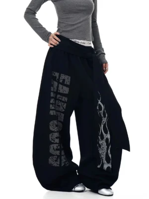 Dark gray inferno wrap wide-leg fleece streetwear sweatpants front view with flame print and asymmetric waist sash