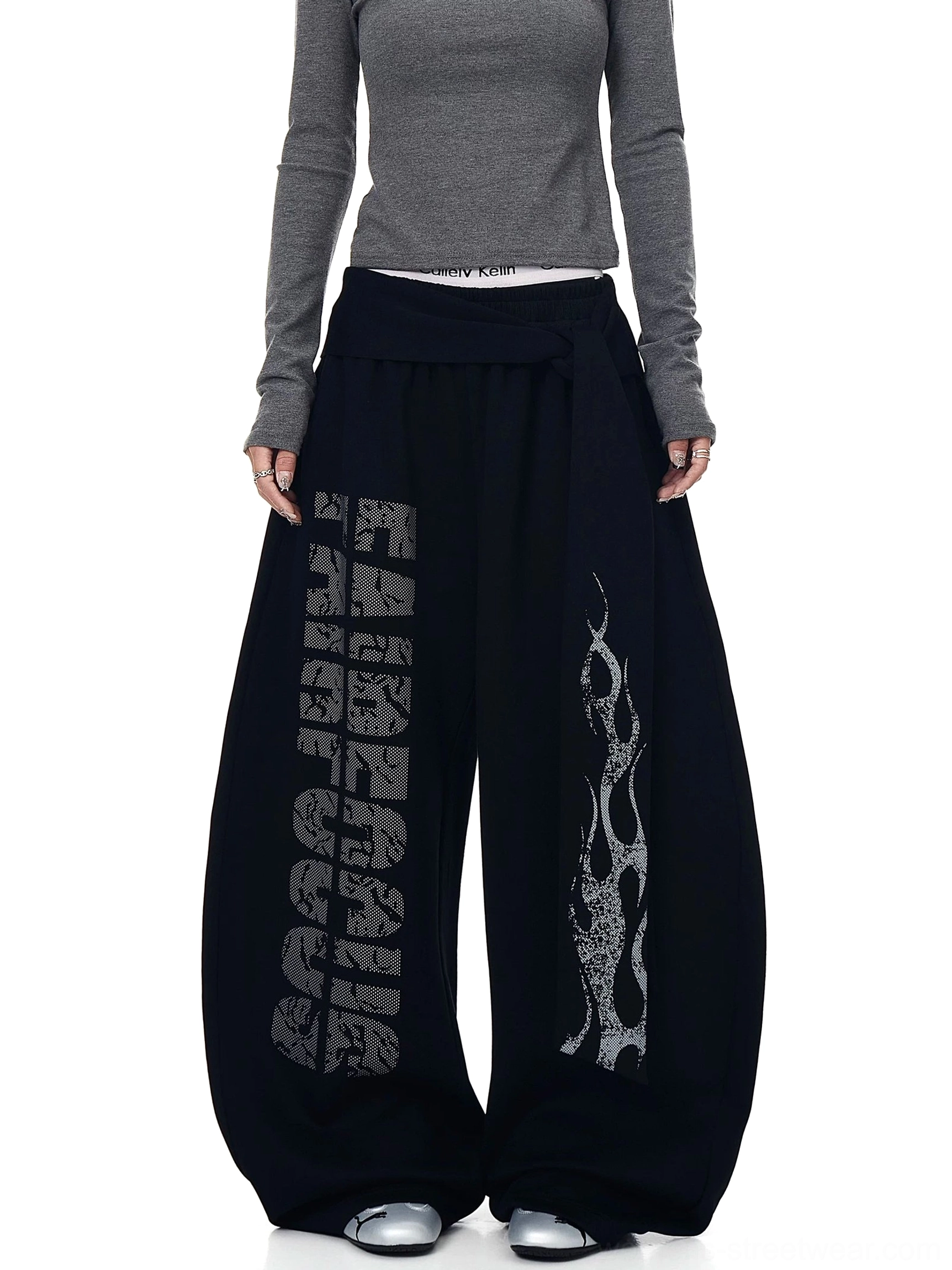 Dark gray oversized wide-leg fleece sweatpants with vintage flame graphics and draped asymmetric wrap waistband