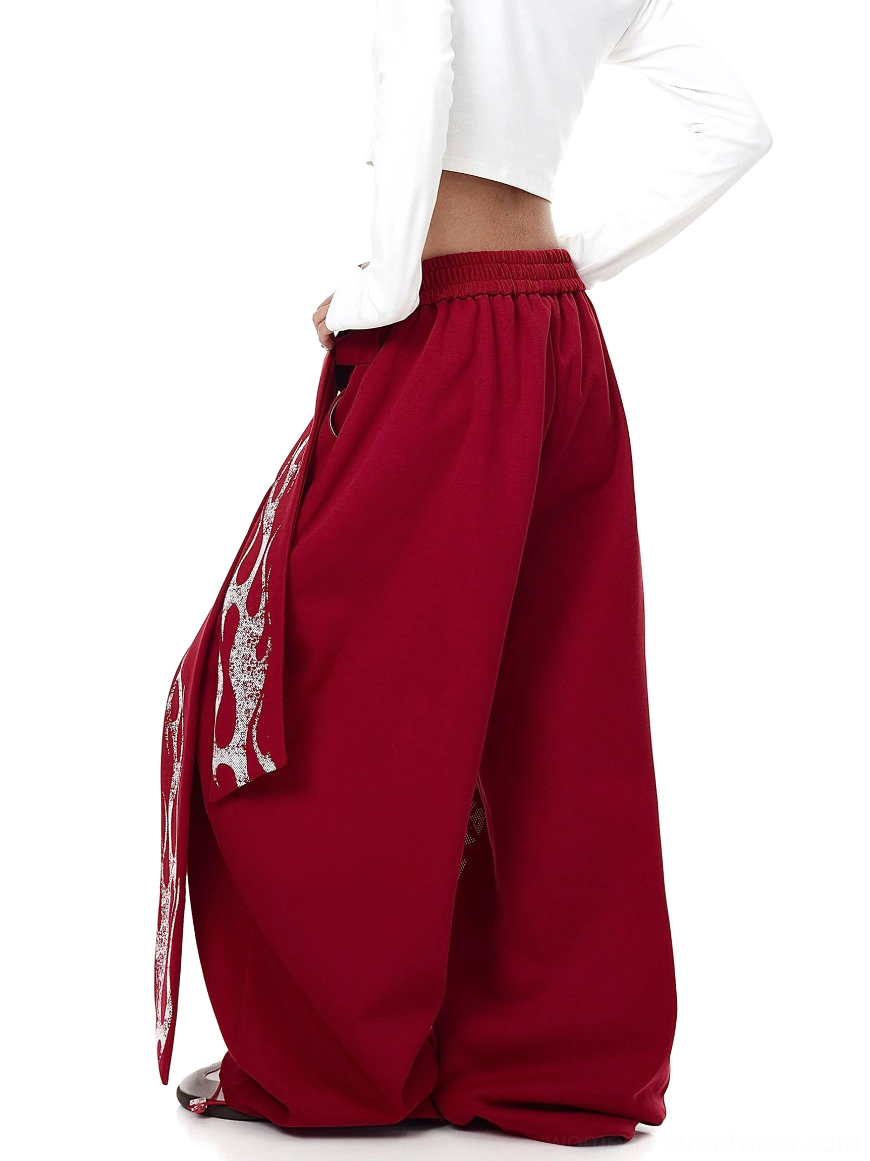 Back view of burgundy red oversized fleece streetwear sweatpants with elastic waist and side wrap sash