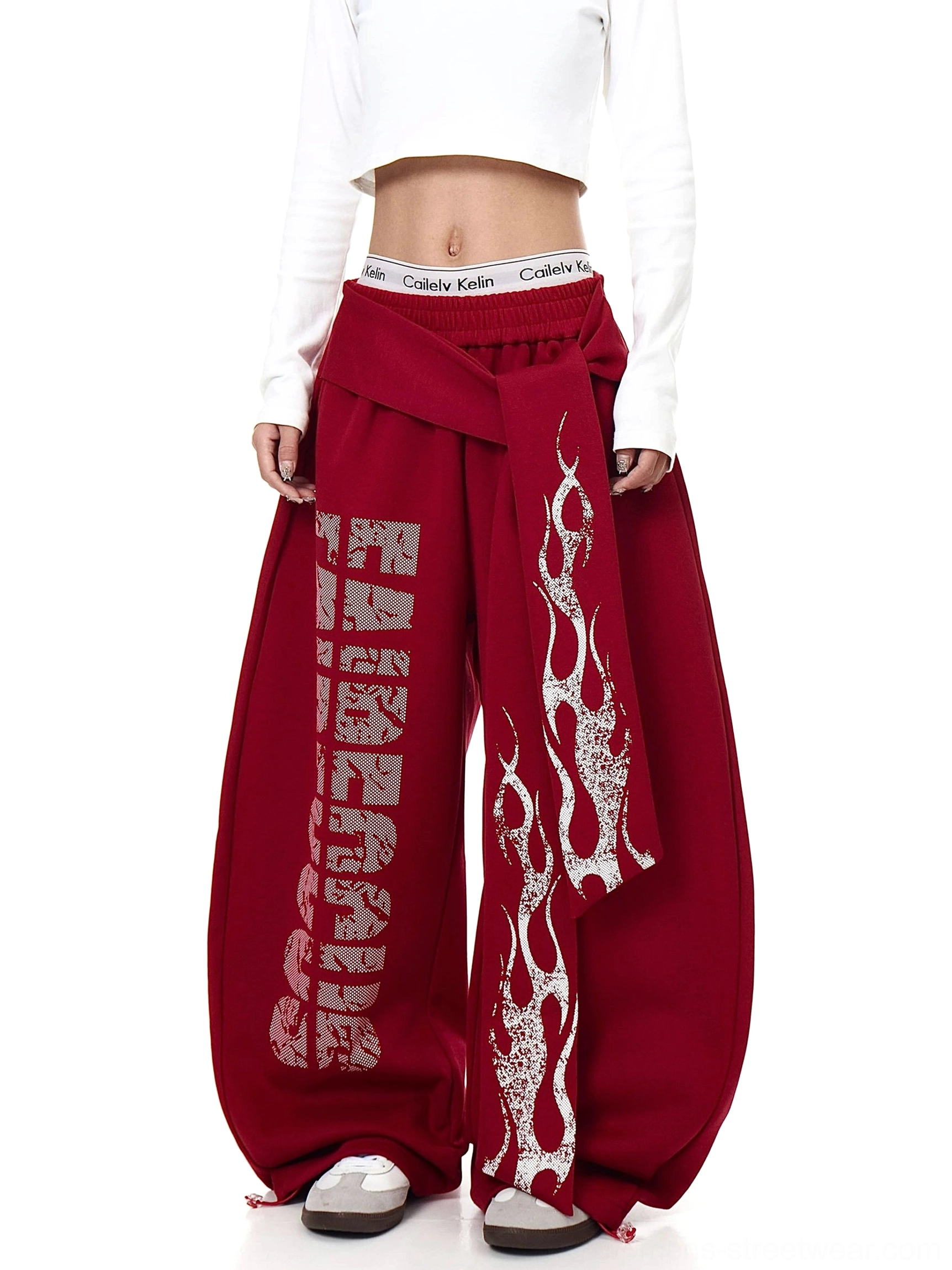 Red oversized graphic fleece sweatpants with wrap waist detail distressed lettering and wide puddle-leg silhouette