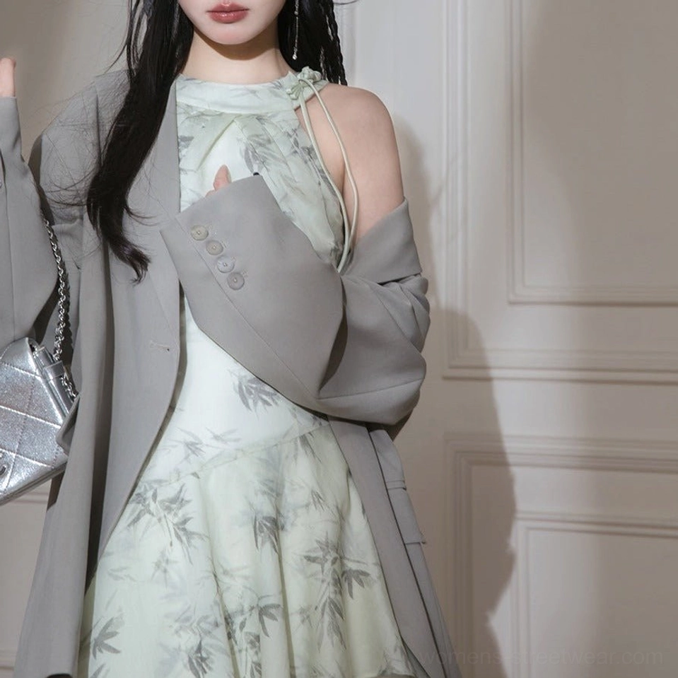 Upper body view of ink bamboo print halter dress with open shoulder detail grey blazer and silver chain handbag