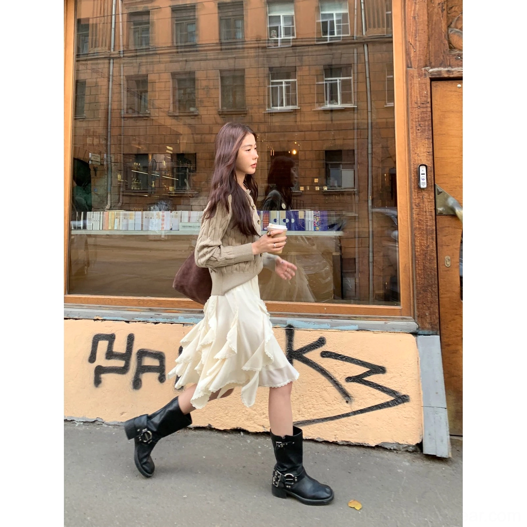 Ivory asymmetric layered ruffle mini skirt paired with black buckle boots in a graffiti streetwear setting