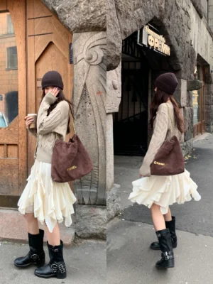 Ivory asymmetric ruffle mini skirt shown from front and back with a knit sweater brown tote bag and black boots