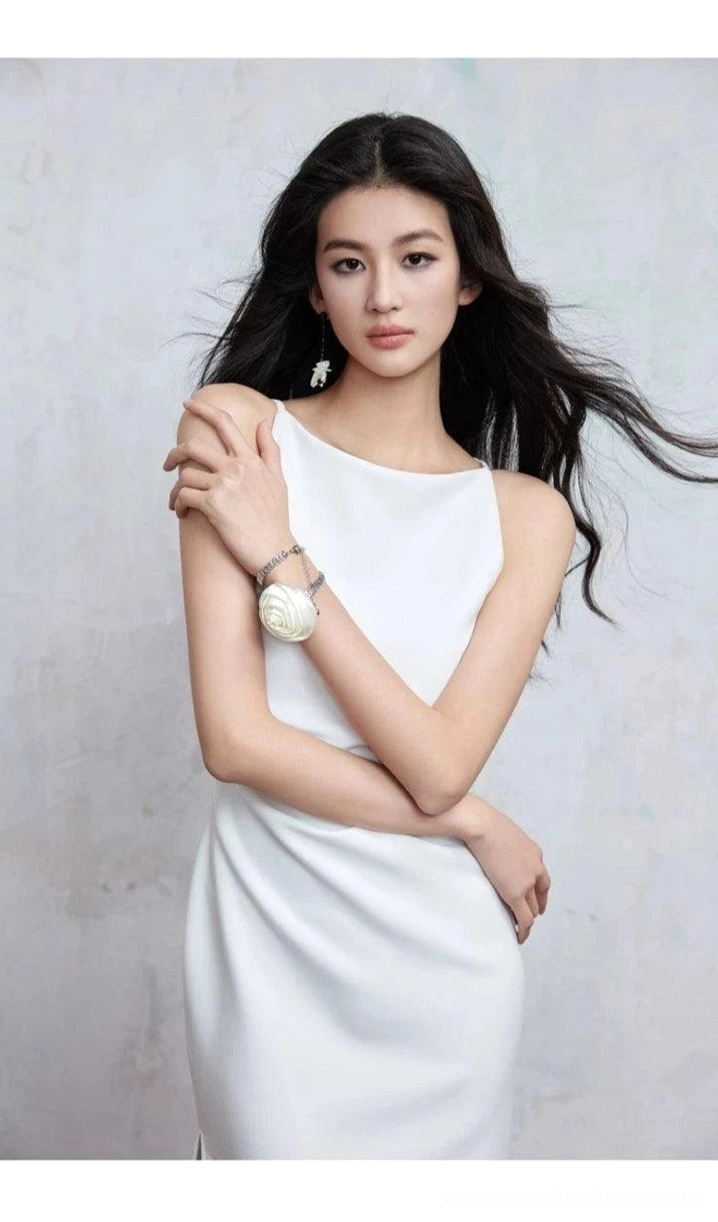 Ivory white boat neck bodycon midi dress close-up showing tailored slim fit, sleeveless neckline, and refined minimalist styling
