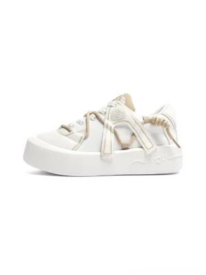 Ivory buckle strap platform sneakers shown from the left side with khaki straps, oversized laces, and a thick sculpted skate-inspired sole
