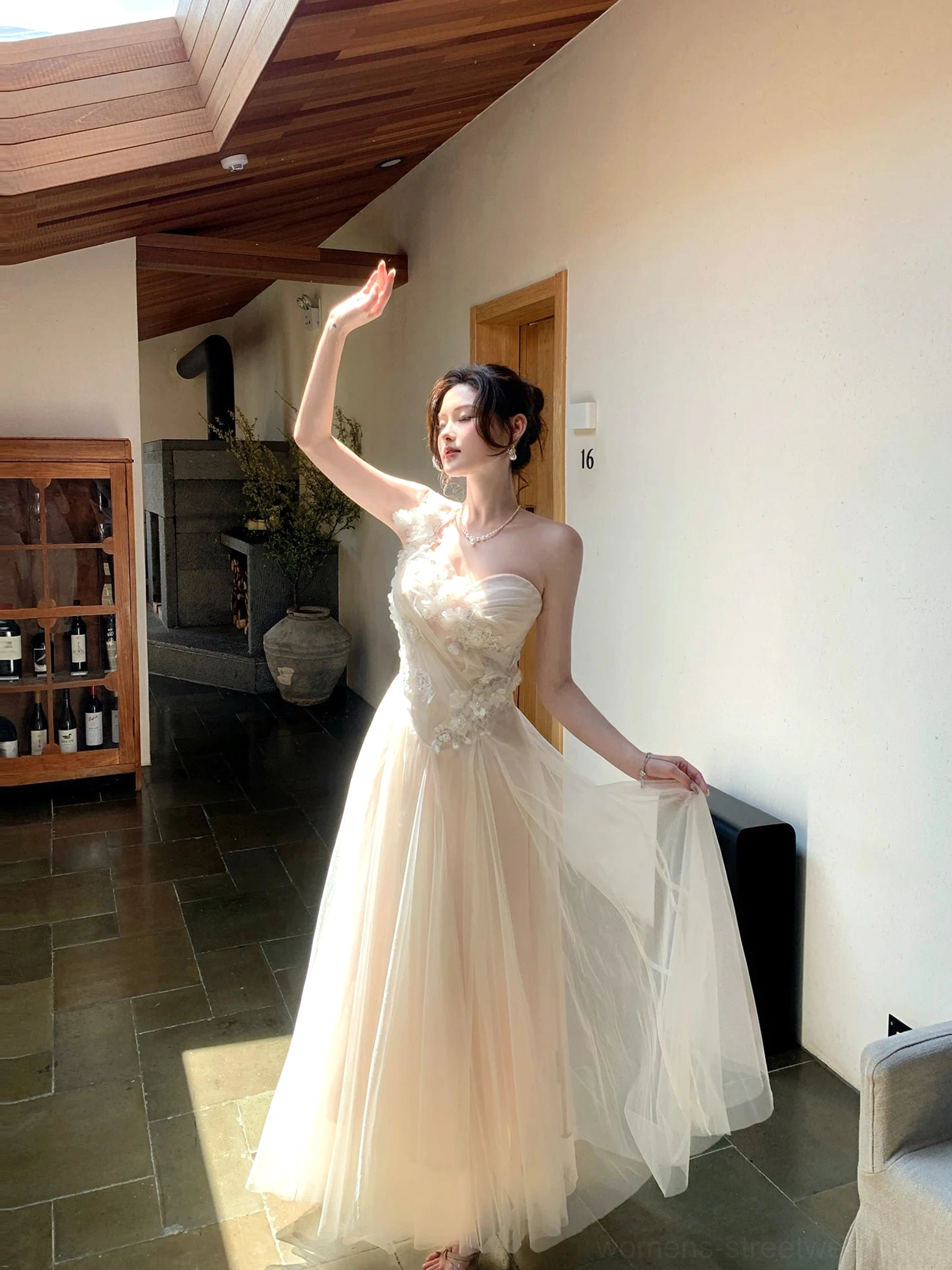 Full front view of an ivory champagne one-shoulder floral embroidered tulle maxi dress with an elegant fitted bodice and flowing floor-length skirt