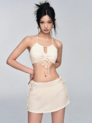 Front view of an ivory crochet halter bikini set with adjustable drawstring ruching and keyhole detail
