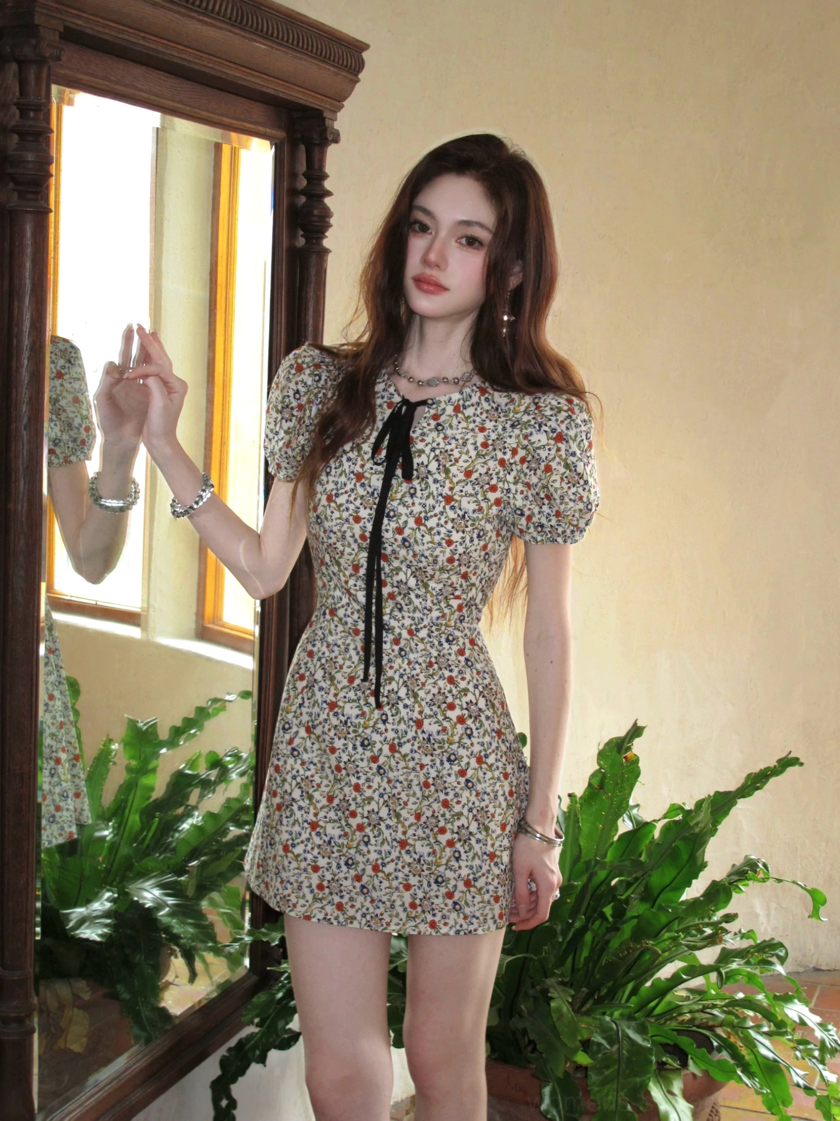 Ivory ditsy floral bow-tie puff sleeve A-line mini dress shown in a vintage mirror setting