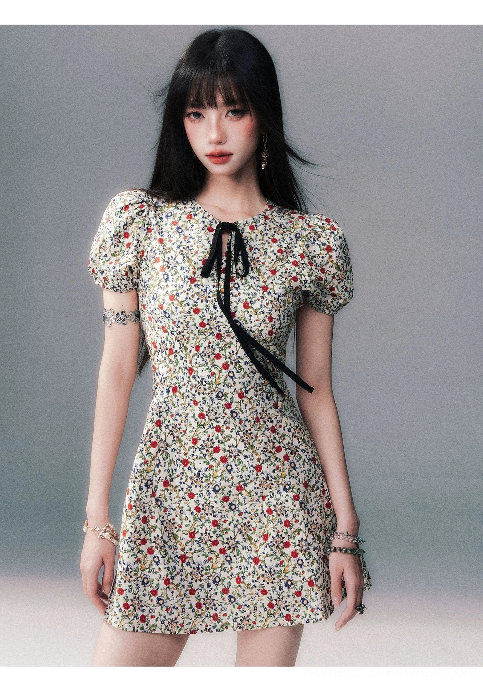 Studio front view of ivory ditsy floral bow-tie puff sleeve fitted waist mini dress