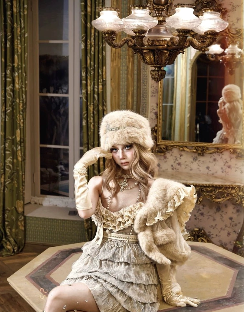 Ivory faux fur lace capelet draped over the arm with a vintage Lolita dress and matching faux fur hat