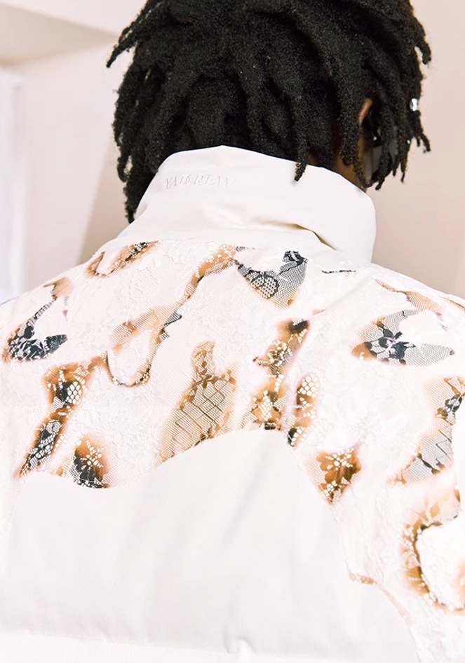 Close-up back view of ivory flame lace cropped puffer jacket showing stand collar and detailed quilted print