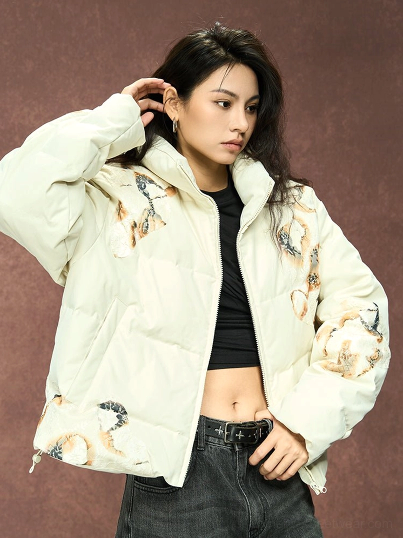 Female model styling an ivory flame lace cropped puffer jacket with a black crop top and low-rise jeans