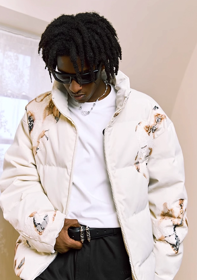 Male model in ivory flame lace cropped puffer jacket with stand collar and bold quilted graphic design