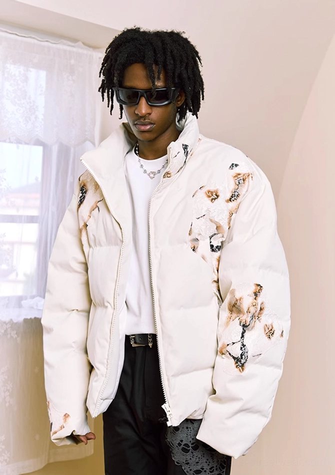 Three-quarter front view of ivory flame lace cropped puffer jacket styled with white t-shirt and black pants