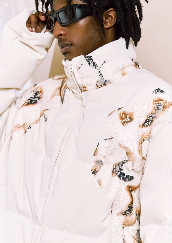 Close-up of the stand collar, zip placket, quilting, and flame lace print on the ivory cropped puffer jacket