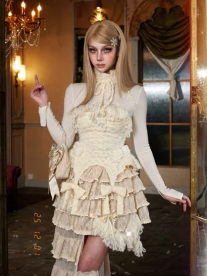Ivory fringe knit corset top styled in a romantic layered ruffle outfit, full front view in a vintage bedroom