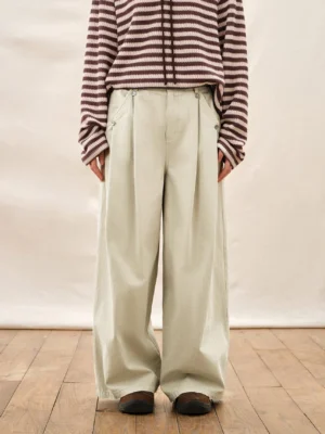 Ivory high waisted pleated wide leg streetwear pants styled with a striped knit top in a full body studio outfit