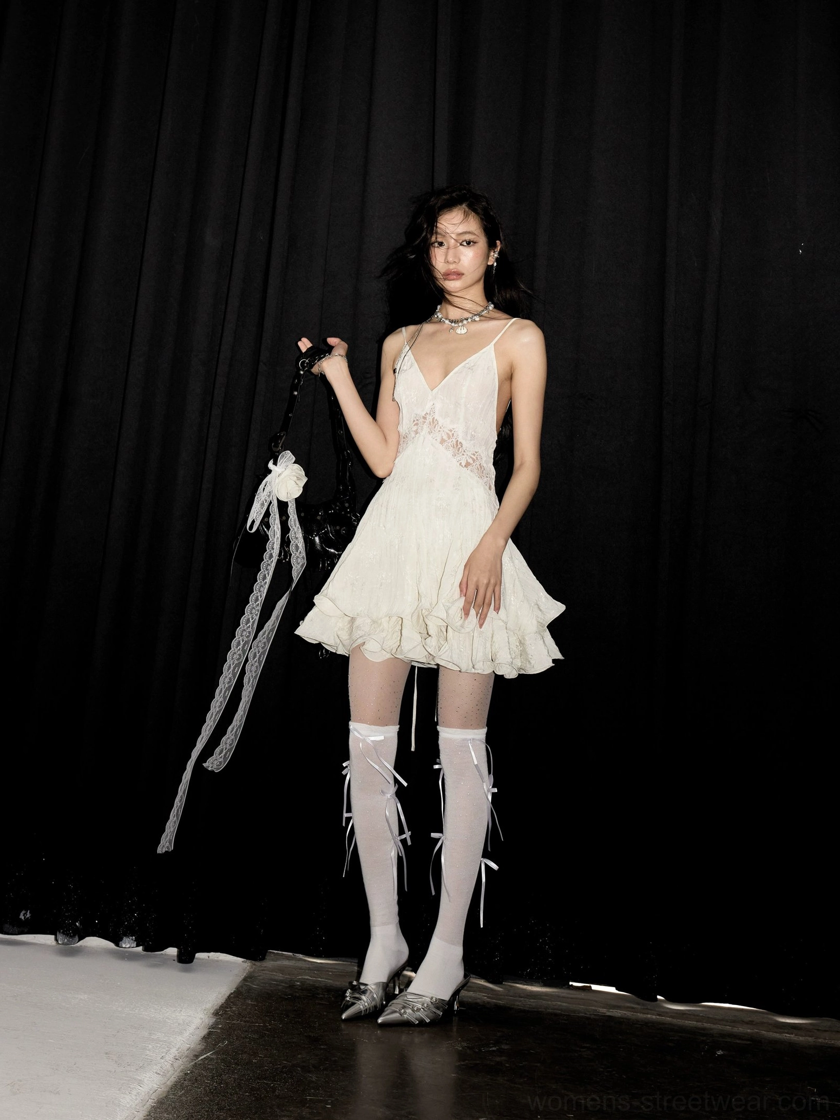 Full front view of ivory lace ruffle hem slip mini dress styled as a romantic Y2K going-out outfit