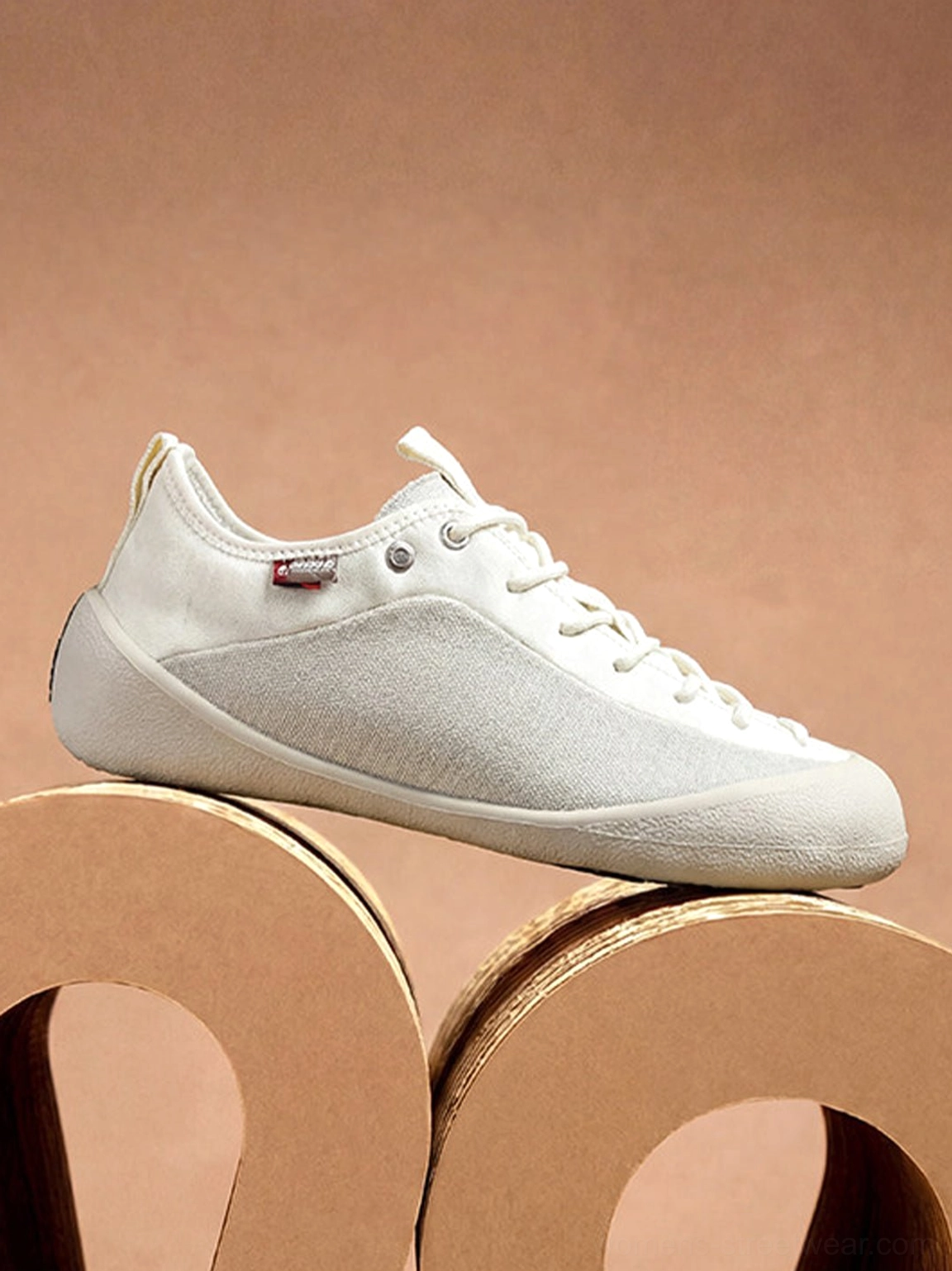 Full side profile of an ivory mesh-panel canvas low-top sneaker in the white gray colorway