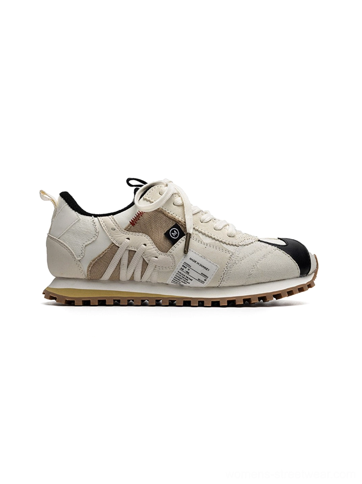 Ivory streetwear runner sneakers with cream technical panels, contrast black details, textile insole, and rubber gum sole