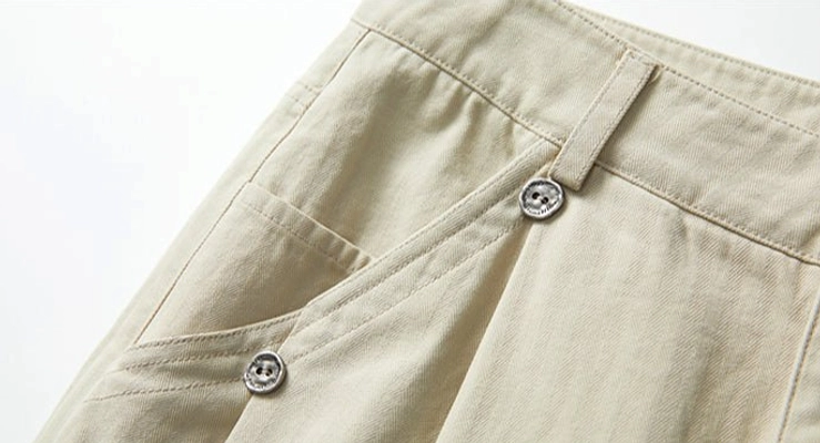 Ivory wide leg cotton pants waist and pocket close up with belt loops metal fasteners and structured tailoring