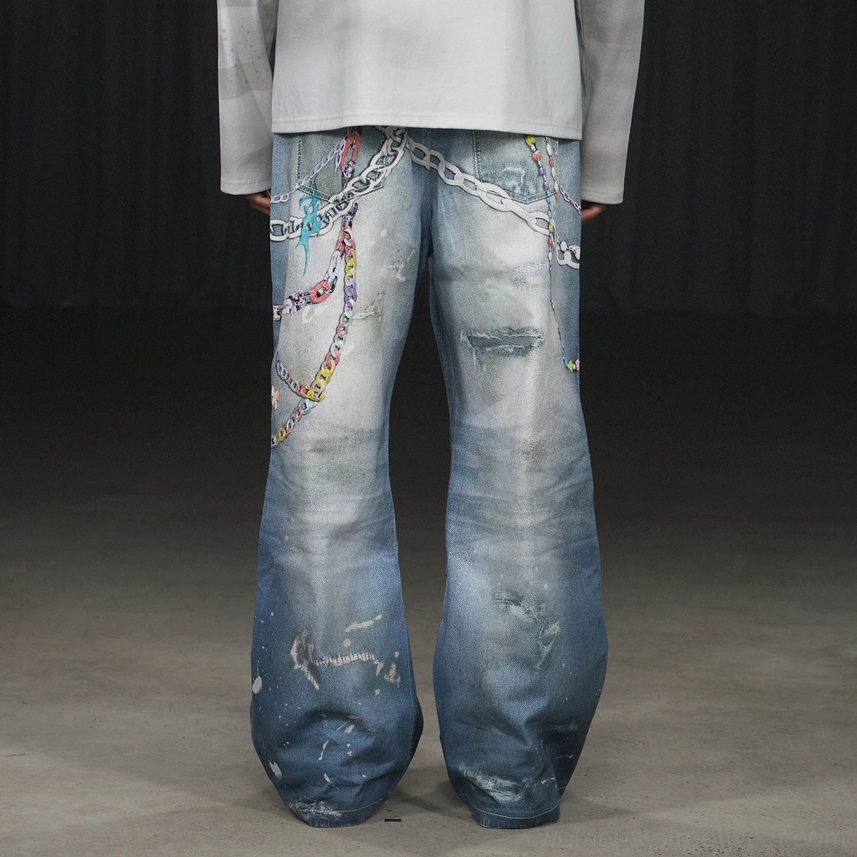 Rear view of faded blue Kawaii wide-leg jeans with chain decorations distressed denim finish and relaxed streetwear silhouette