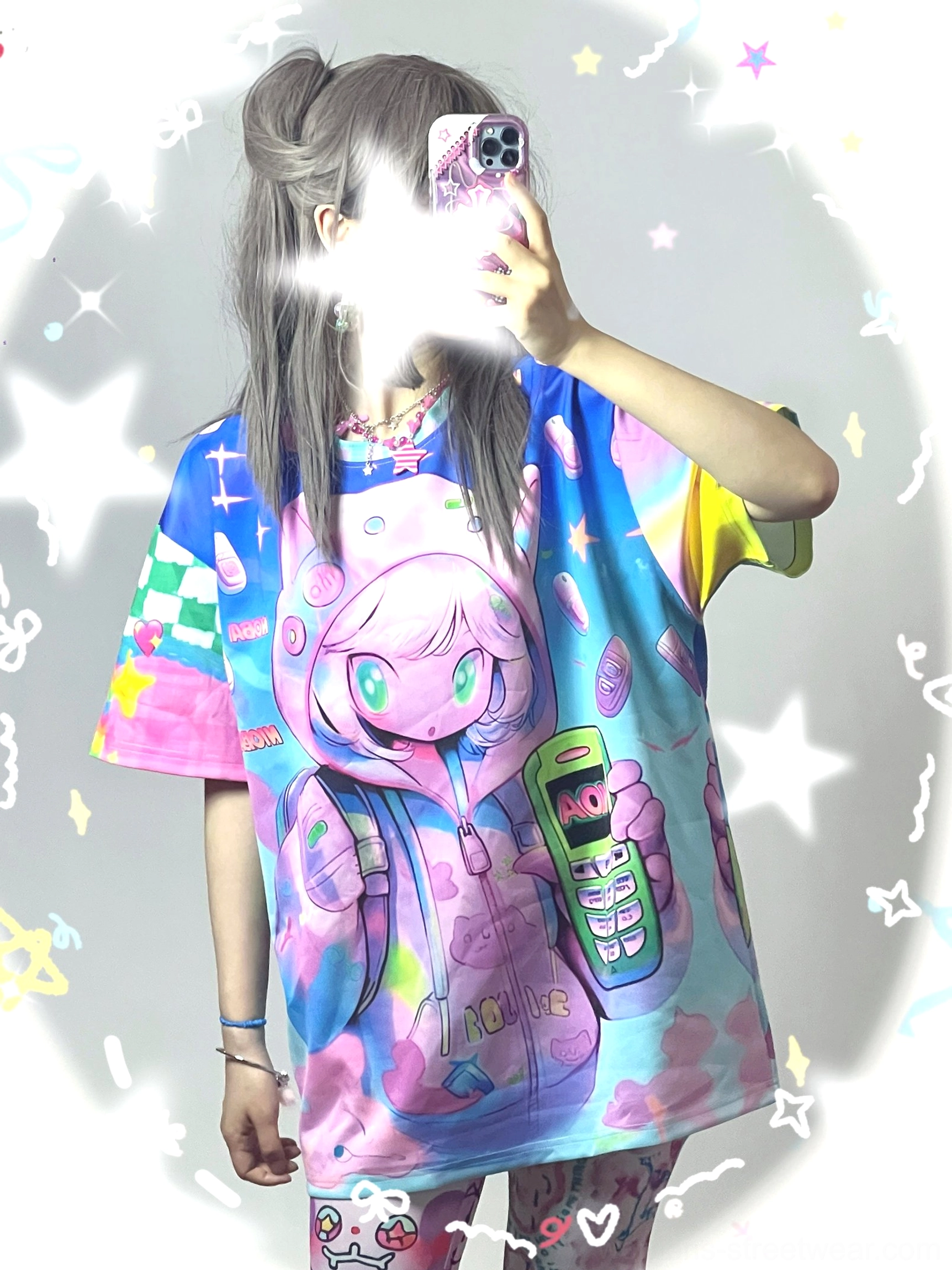 Front view of a kawaii oversized retro mobile phone T-shirt with anime-inspired character print, sparkly star background, pastel colors, and Korean Y2K streetwear aesthetic