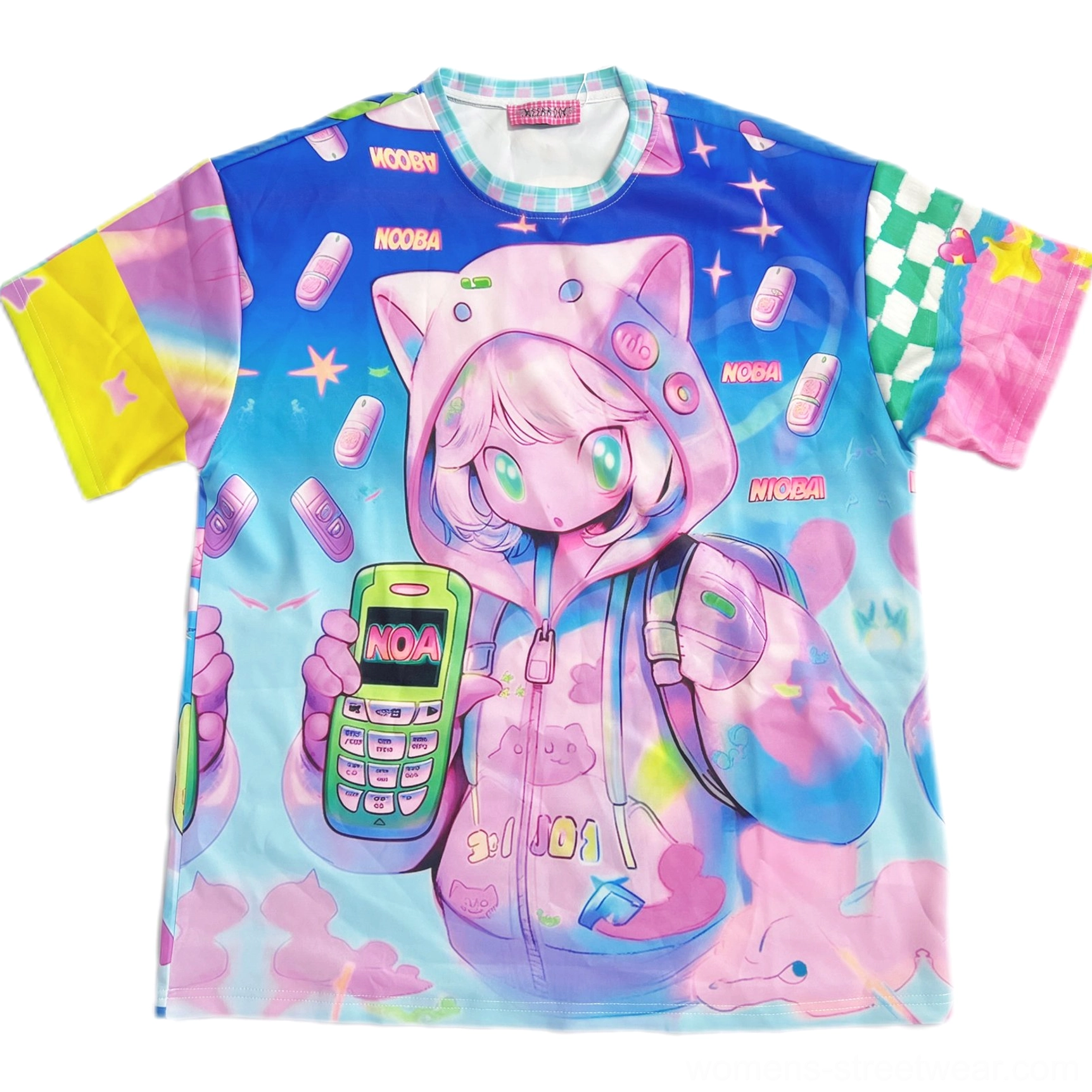 Flat lay view of oversized kawaii retro phone graphic T-shirt showing crew neck, checkered sleeve patches, anime character artwork, colorful mobile phone print, and small text logos