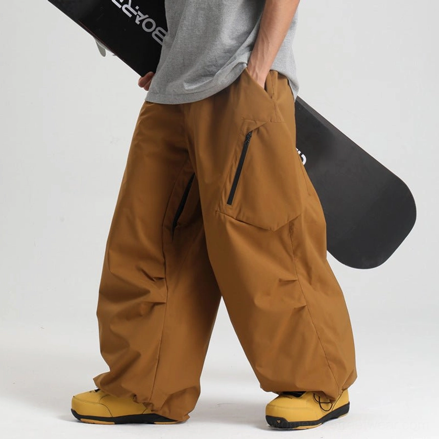 Tan brown khaki beige wide-leg snow pants low side angle male model gray shirt yellow snow boots