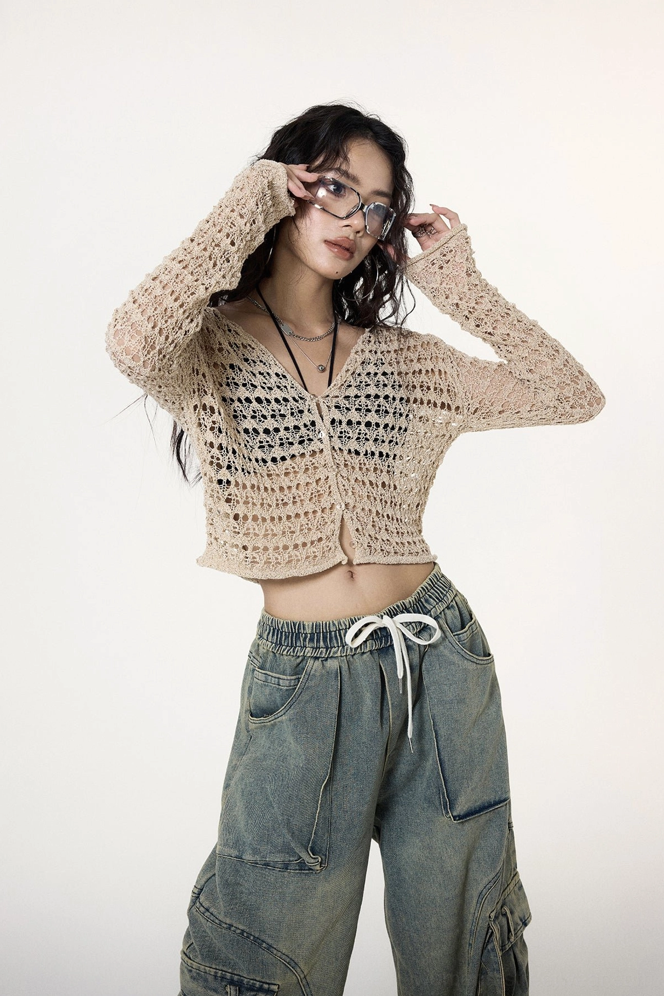 Front view of a model wearing a khaki crochet button cardigan with slim long sleeves and a V-neckline